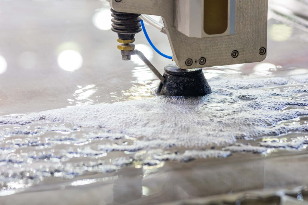 Metalworking industry: High-pressure water jet cutting metal sheet with precision.