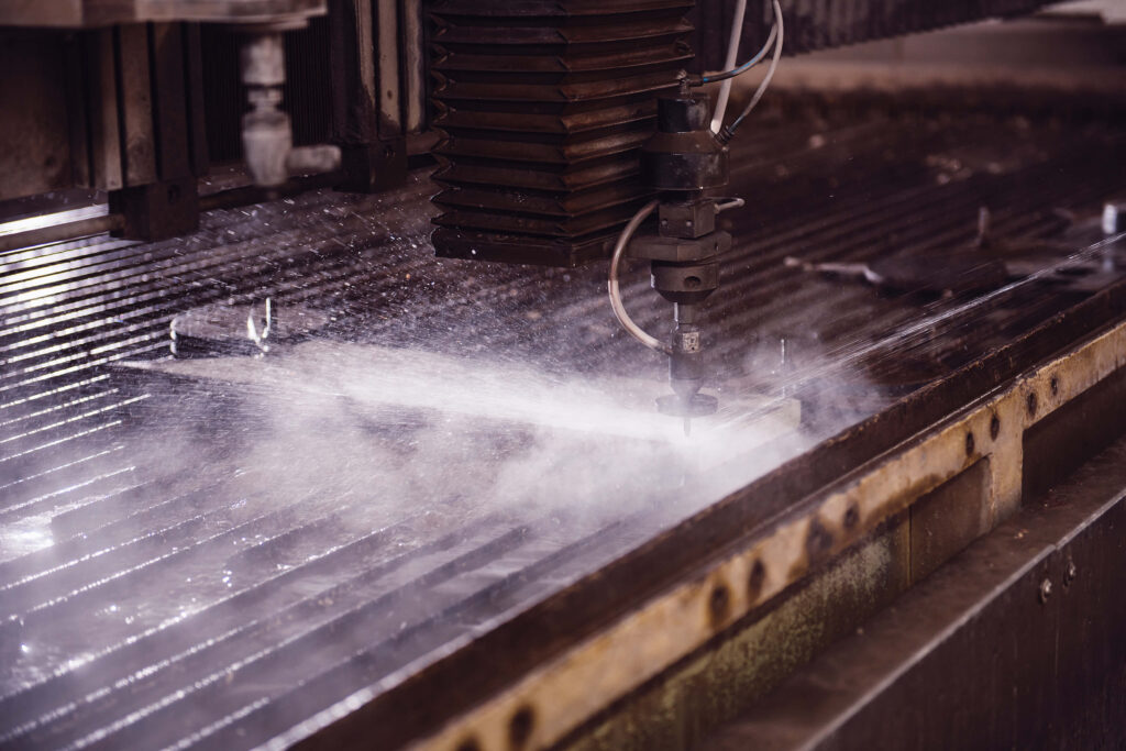 Water jet cutter cutting a steel plate