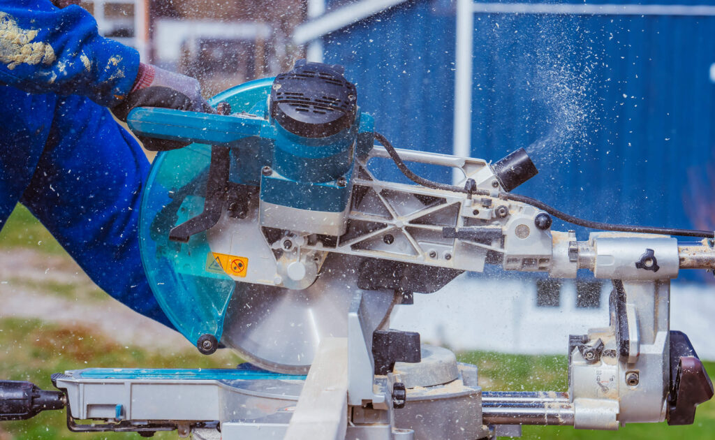 Worker cutting a plank with a circular saw